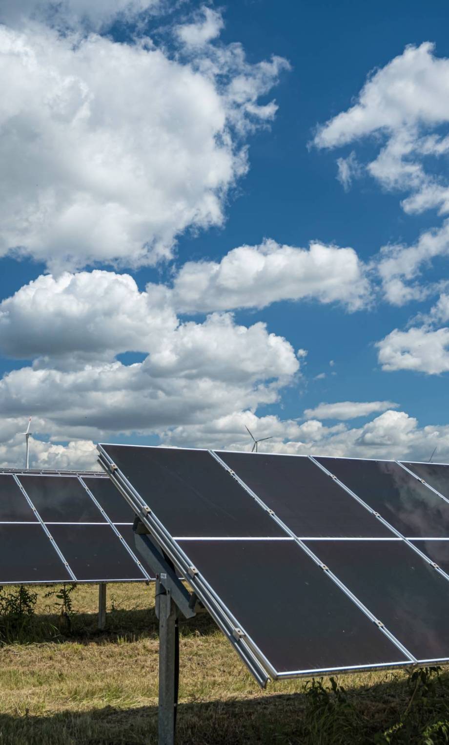 The solar panels used for renewable energy on the field under the sky full of clouds